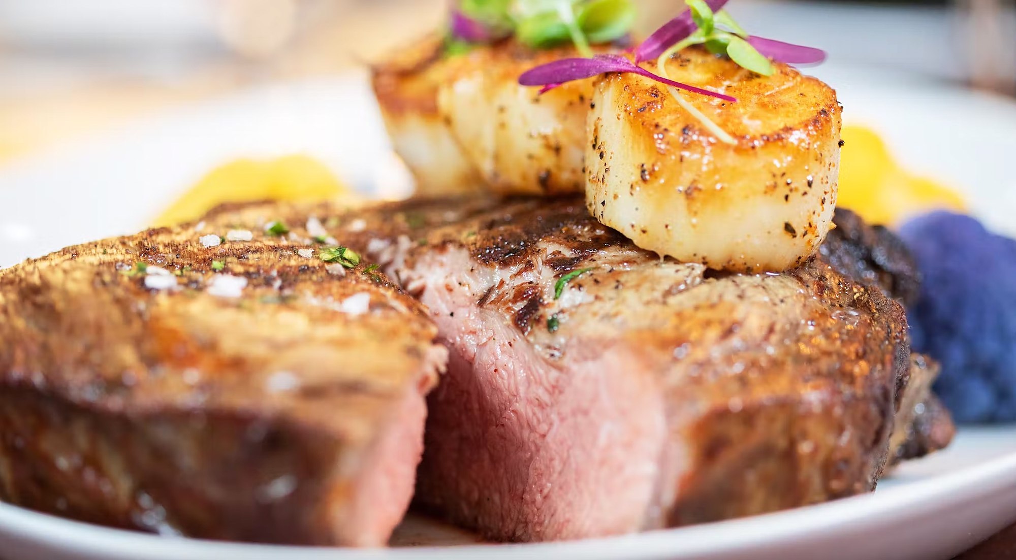A Prime steak finished with seared sea scallops
