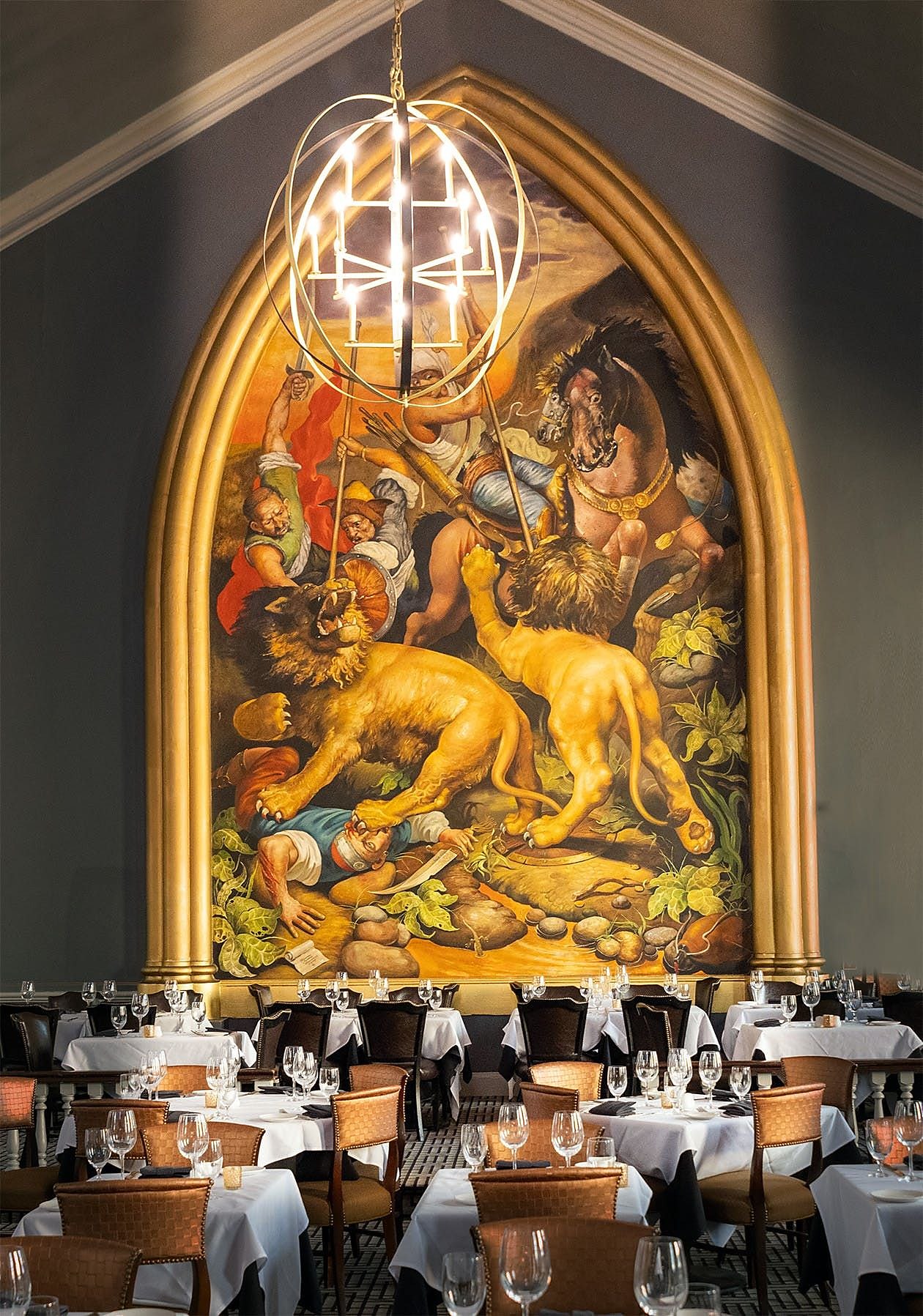 The gilded gothic arch and painted mural above the dining room at OldeStone